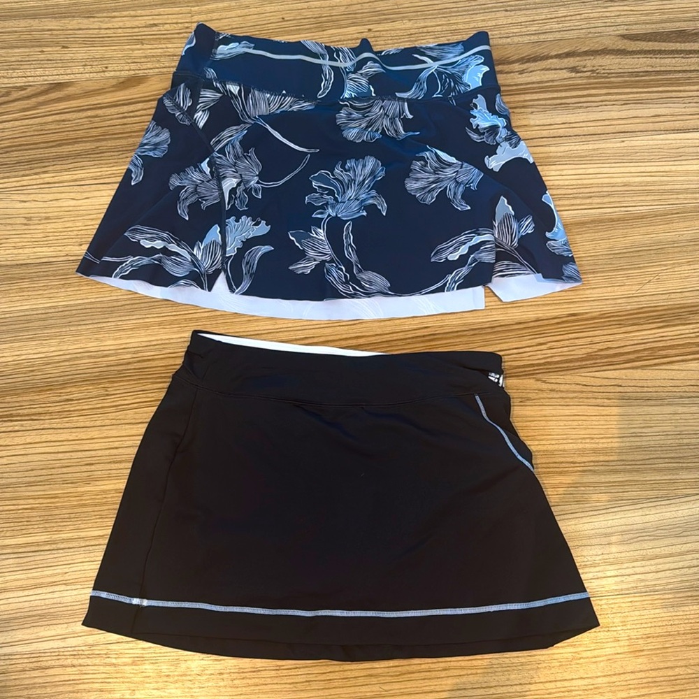 Two golf/tennis skirts. Medium. Excellent condition.  Elastic intact.